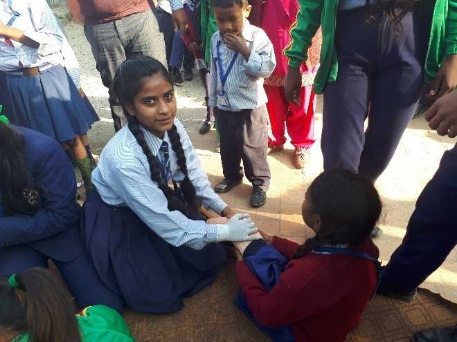 Practicing first aid at a disaster simulation